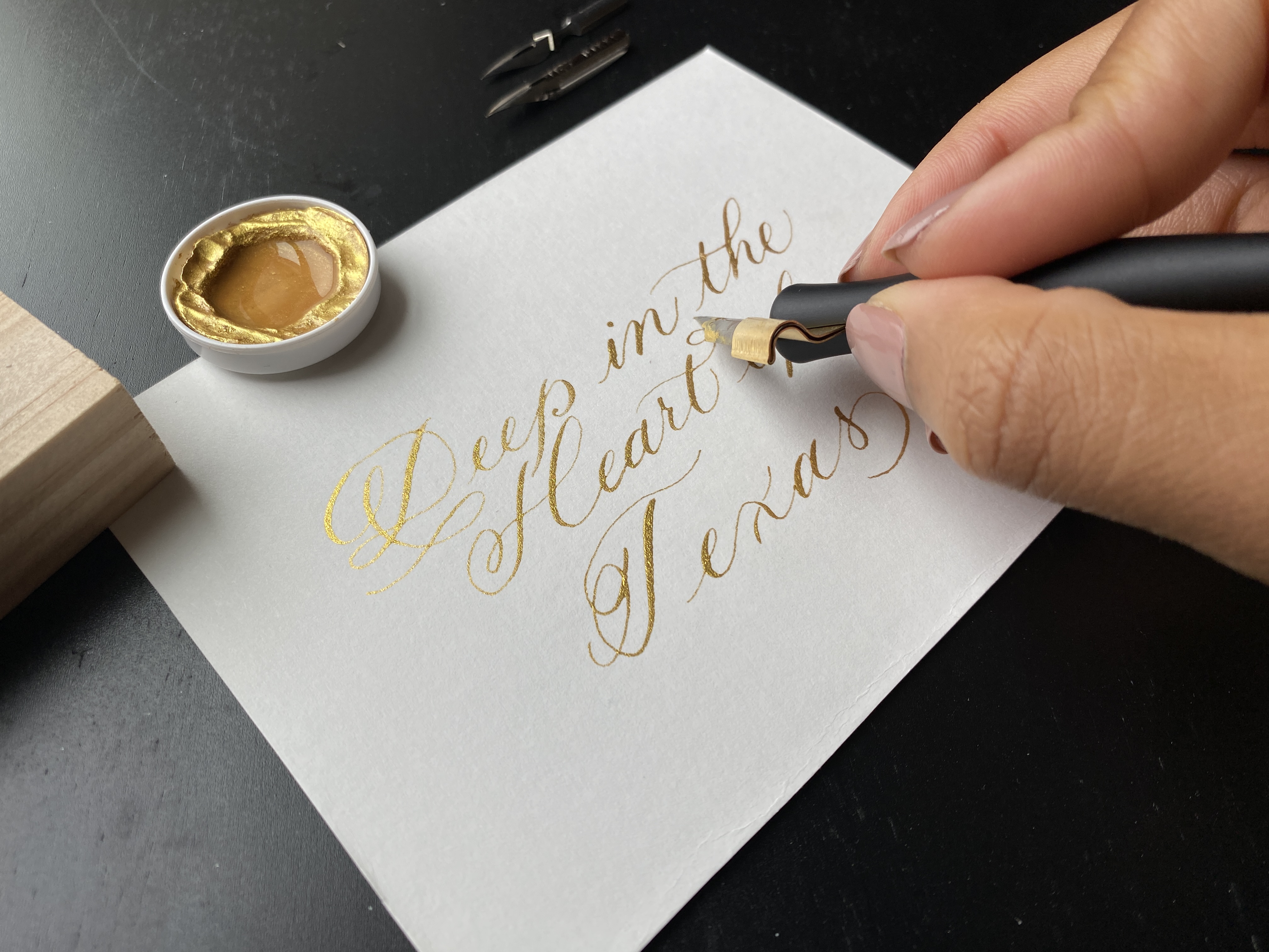 Traditional calligraphy of gold ink on paper