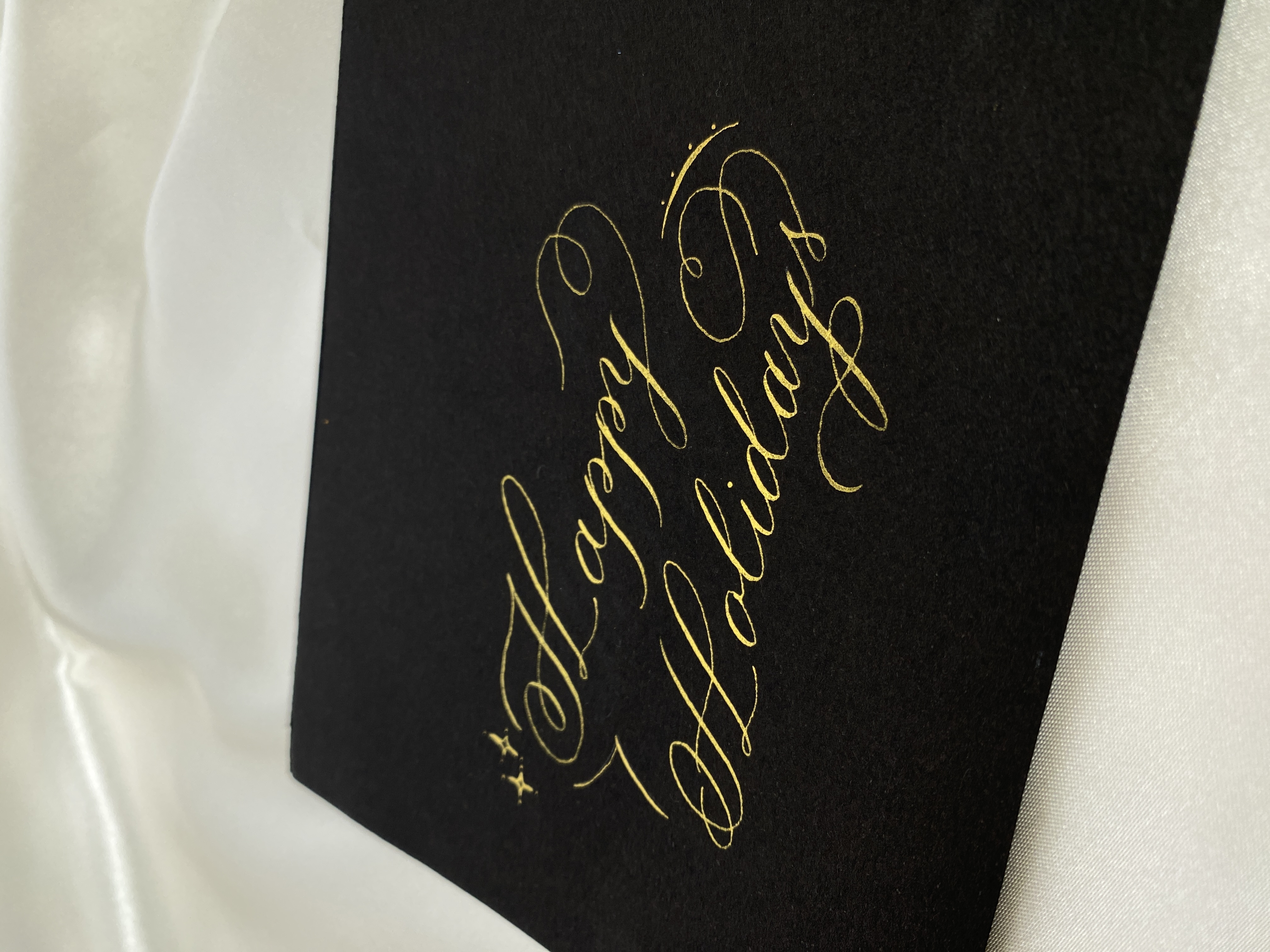 Gold ink caligraphy on black paper